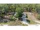 Aerial view of a home nestled among lush trees, showcasing the property and surrounding landscape at 13164 Sw 78Th Place, Dunnellon, FL 34432