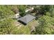 Aerial view of a single Gathering home showcasing its backyard, surrounding wooded area, and lengthy driveway at 13164 Sw 78Th Place, Dunnellon, FL 34432