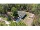 Aerial view of a single-Gathering home featuring a spacious backyard and surrounding wooded area at 13164 Sw 78Th Place, Dunnellon, FL 34432