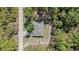Aerial view of home on wooded lot featuring private driveway and partially fenced back yard at 13164 Sw 78Th Place, Dunnellon, FL 34432