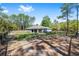 Exterior shot of the rear of the single-Gathering home featuring a large backyard and wooden perimeter fence at 13164 Sw 78Th Place, Dunnellon, FL 34432