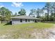 Exterior shot of a single-Gathering home featuring a spacious backyard and covered patio area at 13164 Sw 78Th Place, Dunnellon, FL 34432
