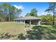 A beautiful single-Gathering home featuring a spacious backyard with a fire pit and covered patio area at 13164 Sw 78Th Place, Dunnellon, FL 34432