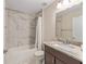Well-lit bathroom features a marble-tiled shower-tub combo and a single sink vanity at 13164 Sw 78Th Place, Dunnellon, FL 34432