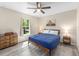 Sun-drenched bedroom features hardwood floors, a full-sized bed, and bright window at 13164 Sw 78Th Place, Dunnellon, FL 34432