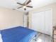 A bright bedroom with a ceiling fan, wood-look floors, and closet at 13164 Sw 78Th Place, Dunnellon, FL 34432