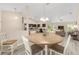 Bright dining area featuring a round table, modern light fixture, and views into the living room and kitchen at 13164 Sw 78Th Place, Dunnellon, FL 34432