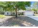 Charming single-story home with stone accents, a two-car garage, and a well-manicured front lawn at 13164 Sw 78Th Place, Dunnellon, FL 34432