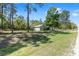 Exterior shot of the front of a single Gathering home featuring a large front yard with green grass at 13164 Sw 78Th Place, Dunnellon, FL 34432