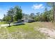 A single-Gathering home featuring a lengthy driveway and well-maintained front yard at 13164 Sw 78Th Place, Dunnellon, FL 34432