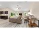 Open-concept living room with modern floors and natural light from windows and sliding glass doors at 13164 Sw 78Th Place, Dunnellon, FL 34432