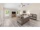Spacious living room featuring neutral paint, modern gray floors, and lots of natural light at 13164 Sw 78Th Place, Dunnellon, FL 34432