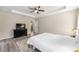 Bright and airy main bedroom featuring tray ceilings, a ceiling fan, neutral walls, and wood-look flooring at 13164 Sw 78Th Place, Dunnellon, FL 34432