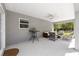 Spacious covered patio with ceiling fan, cozy seating, and convenient access to the backyard at 13164 Sw 78Th Place, Dunnellon, FL 34432