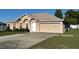Single-story home with a two-car garage, green lawn, and concrete driveway at 13785 Sw 42Nd Court Rd, Ocala, FL 34473
