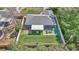 Drone view of the back yard, screened porch, seating area, and synthetic grass at 13800 Sw 33Rd Court Rd, Ocala, FL 34473