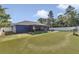 Expansive backyard featuring low-maintenance artificial turf, privacy fence, screened lanai, and ample space for outdoor activities at 13800 Sw 33Rd Court Rd, Ocala, FL 34473