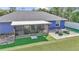 Aerial of home's backyard featuring a screened in patio and outdoor seating area at 13800 Sw 33Rd Court Rd, Ocala, FL 34473