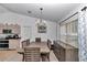 Dining room with vaulted ceilings, chandelier, and sliding door leading to the backyard at 13800 Sw 33Rd Court Rd, Ocala, FL 34473