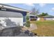 Charming home featuring a two-car garage, manicured landscaping, and inviting curb appeal at 13800 Sw 33Rd Court Rd, Ocala, FL 34473
