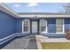 Close-up of the entrance showcasing the architecture, windows, and well-kept landscaping at 13800 Sw 33Rd Court Rd, Ocala, FL 34473