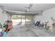 Spacious garage featuring a clean floor and sliding screens allowing natural light at 13800 Sw 33Rd Court Rd, Ocala, FL 34473