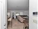 View of the living room with a sectional sofa and wood-look flooring at 13800 Sw 33Rd Court Rd, Ocala, FL 34473