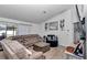 Relaxing living room with a large sectional, coffee table, and natural light at 13800 Sw 33Rd Court Rd, Ocala, FL 34473
