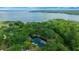 Stunning aerial view of a wooded property with pond and lake access and a pin marking the residence location at 14190 Ne 209Th Ct, Fort Mc Coy, FL 32134