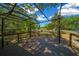 Inviting backyard deck featuring an iron pergola, ideal for outdoor living and entertaining at 14190 Ne 209Th Ct, Fort Mc Coy, FL 32134