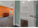 Bedroom with large walk in closet and view from the bedroom with orange wall and wood dresser at 14190 Ne 209Th Ct, Fort Mc Coy, FL 32134