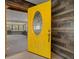 Bright entryway featuring a vibrant yellow door with decorative glass and an inviting glimpse into an airy interior at 14190 Ne 209Th Ct, Fort Mc Coy, FL 32134