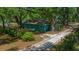 Charming single-story home with mature trees, a grassy yard, and a long driveway that adds to the property's appeal at 14190 Ne 209Th Ct, Fort Mc Coy, FL 32134