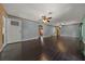 Spacious living room showcasing dark hardwood floors, fresh paint, and abundant natural light at 14190 Ne 209Th Ct, Fort Mc Coy, FL 32134