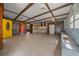 Spacious living room with exposed beams, wood paneled wall and an adjacent kitchenette for flexible entertaining at 14190 Ne 209Th Ct, Fort Mc Coy, FL 32134