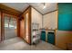 This room has orange walls, wood-look tile floors, and an open doorway leading to another room at 14190 Ne 209Th Ct, Fort Mc Coy, FL 32134
