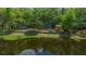 A view of the home from the water, with mature trees and a waterfront location at 14190 Ne 209Th Ct, Fort Mc Coy, FL 32134