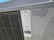 Close-up of a central air conditioner with detailed information on the unit's specifications and certifications at 1441 Admiral Nimitz Ave, Daytona Beach, FL 32124