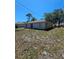 Spacious backyard with a simple patio, offering a blank canvas for outdoor enjoyment and landscaping opportunities at 1441 Admiral Nimitz Ave, Daytona Beach, FL 32124