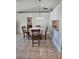 Bright dining room featuring a stylish chandelier and convenient pass-through to the kitchen at 1441 Admiral Nimitz Ave, Daytona Beach, FL 32124