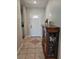 Inviting entryway with tile flooring, a white front door, and a decorative cabinet with dishes at 1441 Admiral Nimitz Ave, Daytona Beach, FL 32124