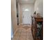 Inviting entryway with tile flooring, a white front door, and a decorative cabinet with dishes at 1441 Admiral Nimitz Ave, Daytona Beach, FL 32124