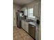 Functional kitchen featuring tile floors, sleek countertops, stainless steel appliances, and painted cabinets at 1441 Admiral Nimitz Ave, Daytona Beach, FL 32124