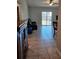 Living room with tile flooring, ceiling fan and sliding glass doors to the patio with comfortable seating at 1441 Admiral Nimitz Ave, Daytona Beach, FL 32124
