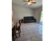 Living room with tile flooring, ceiling fan and sliding glass doors to the patio with comfortable seating at 1441 Admiral Nimitz Ave, Daytona Beach, FL 32124