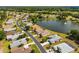 Aerial view of the community, featuring a tranquil lake, lush greenery, and well-kept houses at 15426 Sw 14Th Avenue Rd, Ocala, FL 34473