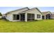 A well-maintained backyard with lush green grass and a view of the screened lanai at 15426 Sw 14Th Avenue Rd, Ocala, FL 34473