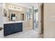 Modern bathroom featuring marble floors, vanity, and glass-enclosed shower at 15426 Sw 14Th Avenue Rd, Ocala, FL 34473