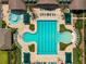 Top-down aerial view showcasing a resort-style community pool with lush landscaping and lounge chairs at 15426 Sw 14Th Avenue Rd, Ocala, FL 34473