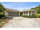 Charming home showcasing a well-maintained exterior, attached garage and mature landscaping at 15426 Sw 14Th Avenue Rd, Ocala, FL 34473